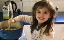 Matilda helps dad in the kitchen.